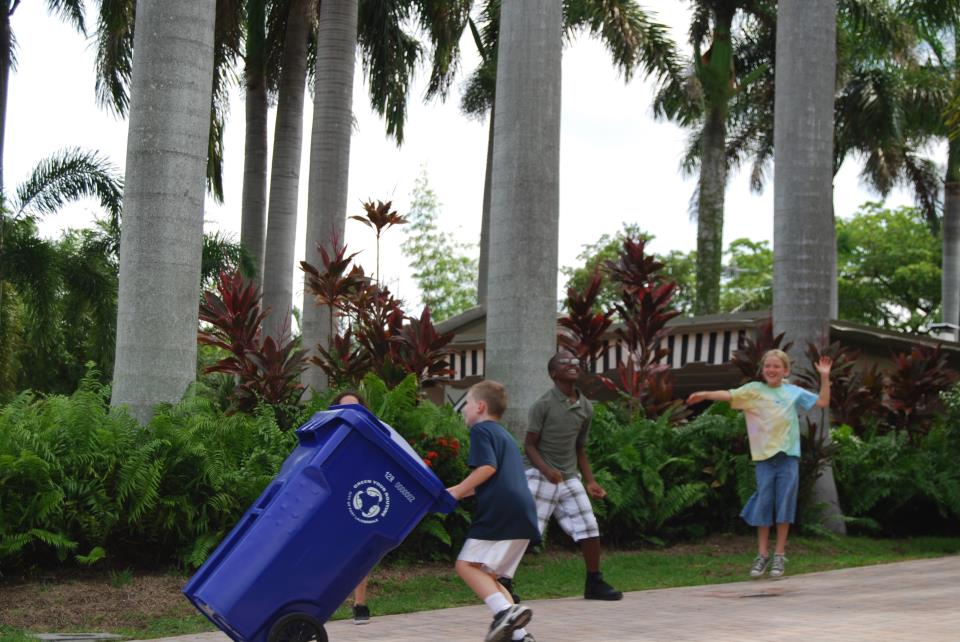 Kids wheeling blue cart